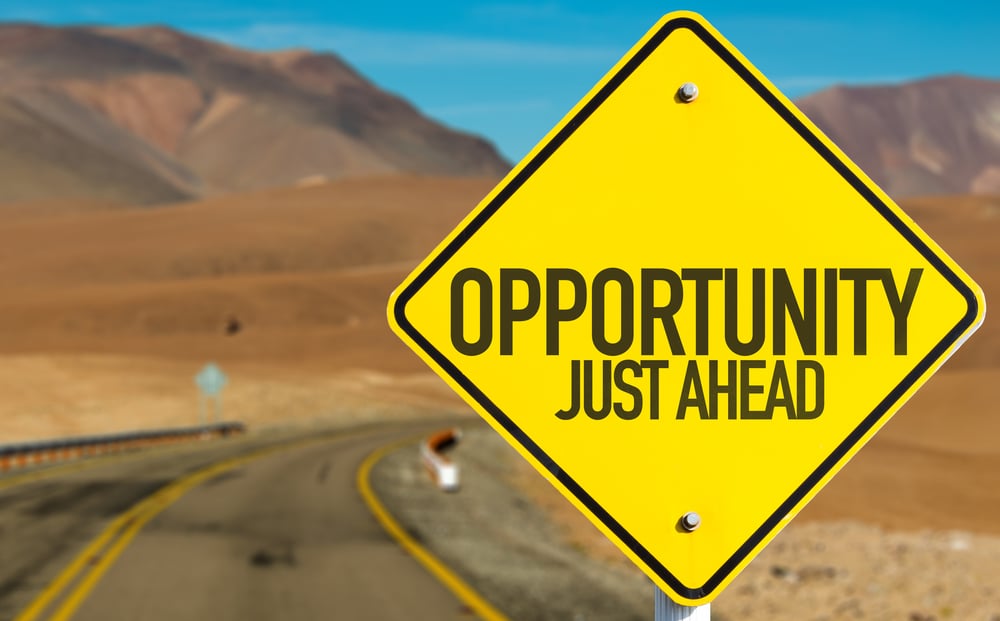An image of a road sign that says opportunity just ahead